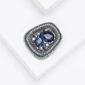 Vintage brooch with blue pear-shaped crystals and multicolor rhinestones on silver base