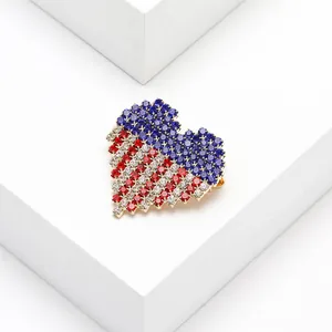 Macro view of heart-shaped brooch featuring red, white, and blue rhinestone inlay