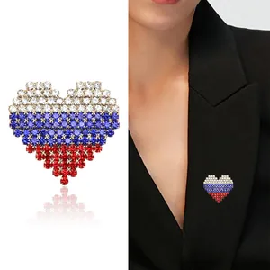 Rhinestone heart brooch with tricolor national flag pattern on black blazer lapel