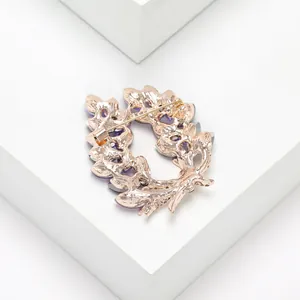 Detail view of the rose gold olive branch brooch back with secure pin and safety clasp