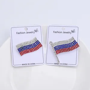 Macro shot of Russian flag brooch pins with sparkling white blue and red rhinestones