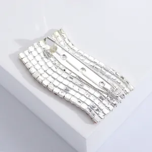 Detail view of the silver clasp and pin mechanism on a rhinestone flag brooch