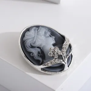 Vintage cameo brooch with lady relief and sparkling crystal accents on silver frame