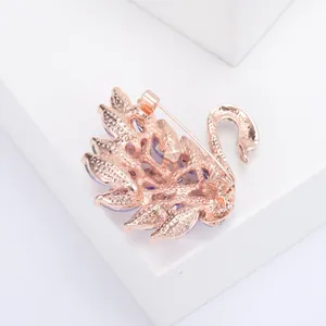 Detail view showing the rose gold plated back and secure pin clasp of the swan brooch