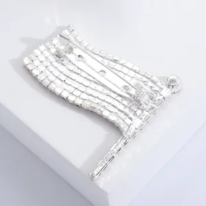 Detailed back view showing the metal pin fastening of the rhinestone flag brooch