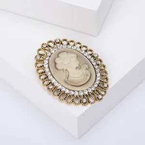 Vintage Victorian style cameo brooch with crystal alloy frame on white display