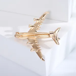 Detailed back view of golden airplane brooch showing the secure pin fastener and metal craft