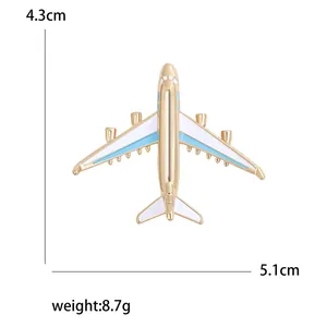 Golden airplane brooch with blue and white enamel, 5.1cm width aviation fashion accessory