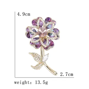 Exquisite crystal flower brooch in gold with purple petals and pink center crystal