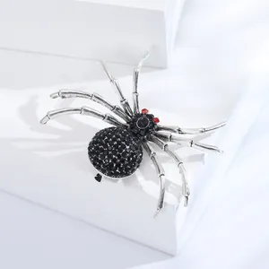 Makro-Detail der gotischen Spinne-Brosche mit schwarzen Strasssteinen und roten Augen