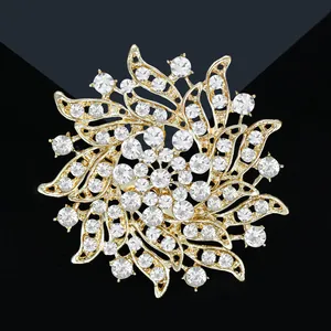 Exquisite gold floral sunburst brooch with sparkling rhinestones in a centered macro view