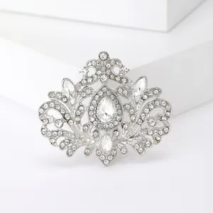 Broche vintage élégante en métal argenté avec strass blancs et pierre en forme de goutte