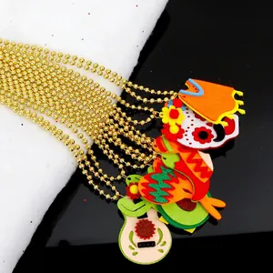 Detail of felt Cinco de Mayo charms with skull and guitar on golden bead chain