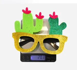 Macro shot showing 20.3g weight of cactus party glasses with gold glitter and green fabric