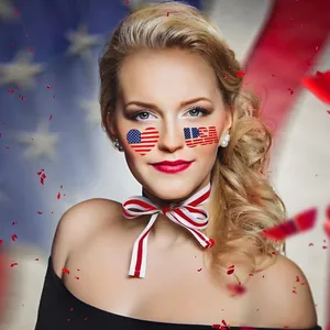 Close-up of USA heart flag face stickers and red white blue striped bow for Independence Day