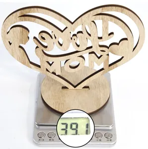 Hollow heart-shaped wooden Love MOM ornament on a digital scale weighing 39.1 grams