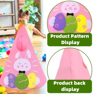 Toddler playing with a pink Easter felt cone tree featuring rabbit and egg decorations
