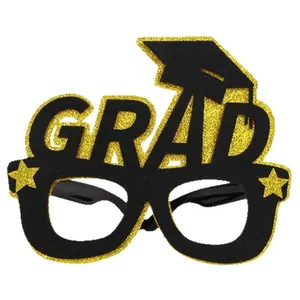Festive graduation party glasses with gold glitter GRAD letters and mini mortarboard cap