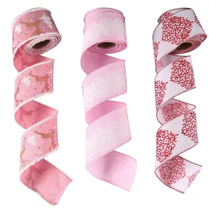 Pink Christmas ribbon set with gold reindeer, lace patterns, and red scroll designs