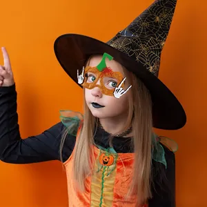 Detail of girl in pumpkin mask, wizard hat, and orange dress for Halloween party costume