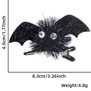 Glittery black bat hair clip with plush pompom and size measurements for Halloween party