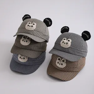 Detail of five plaid baby baseball hats with panda ears and cartoon embroidery patches