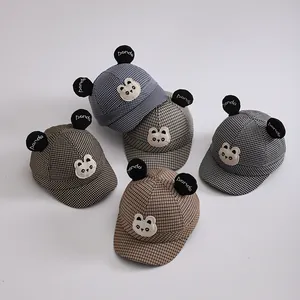 Detail showing five colors of cotton panda baseball caps with plaid patterns and ears