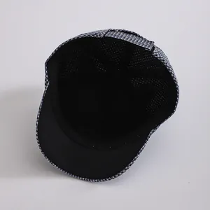 Detailed view of kids baseball cap with breathable mesh lining and houndstooth pattern