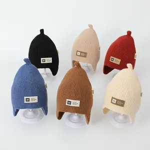 Detailed display of knit beanies with earflaps in six colors for children and babies
