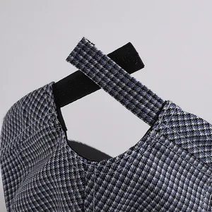 Detail of adjustable Velcro strap on a blue and white houndstooth kids baseball cap