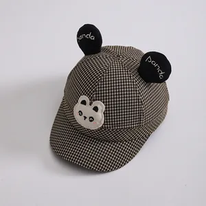 Detail of baby baseball cap with panda ears and brown houndstooth pattern for toddlers