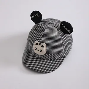 Close-up of kids panda baseball cap featuring houndstooth pattern and 3D ears detail