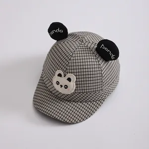 Close-up of kids plaid baseball cap with panda patch and 3D decorative ears