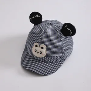 Detail view of toddler baseball cap featuring panda ears and blue houndstooth pattern