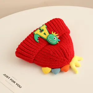 Winter baby knit hat with cute cartoon dinosaur design in red color for warmth