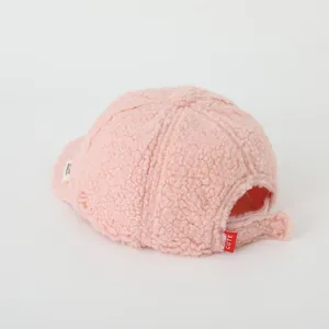 Detail of pink fleece baseball cap with adjustable Velcro strap and a cute red woven label