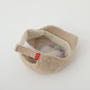 Detail of beige fleece baseball cap showing interior lining, sweatband and adjustable strap