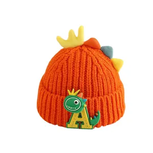 Winter kids orange knitted dinosaur hat with cartoon patch and warm rolled cuff
