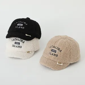Close-up of thick sherpa fleece fabric texture on winter baseball caps with embroidery