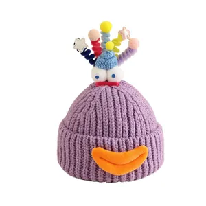 Purple cartoon monster knit hat with funny eyes and colorful spring top for kids