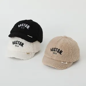 Detail view of winter kids baseball caps with plush fleece texture and BOSTON embroidery