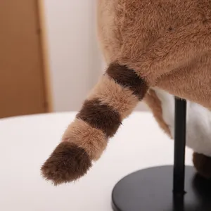 Detailed close-up of the plush raccoon hat's fluffy striped tail and soft texture