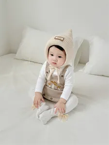 Detail of baby winter knit set with pointed witch hat and mushroom embroidery dress