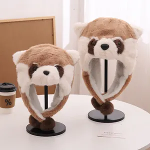 Detailed view of raccoon-style plush trapper hats with earflaps and soft pom-poms