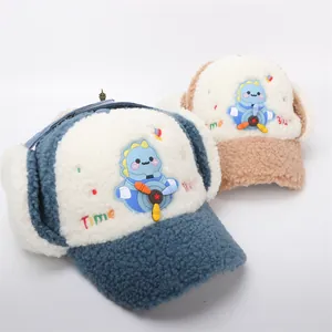 Detailed plush texture of blue and brown kids dinosaur pilot hats with warm earflaps