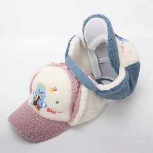 Detail of warm winter trapper hat with fleece lining and cute dinosaur embroidery