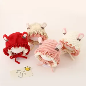 Detailed view of knitted baby hats with rabbit ears and warm lining in multiple colors