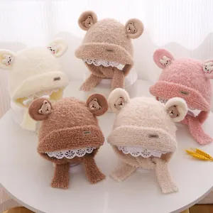 Detailed view of plush kids' bear ear hats with lace trim and soft fleece texture