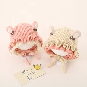 Detailed view of baby knit hat featuring rabbit ears and decorative sequin bows