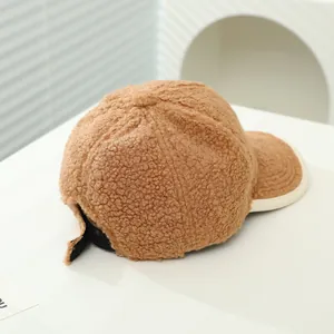 Detailed back view of a brown fleece baseball cap showing adjustable strap and soft texture